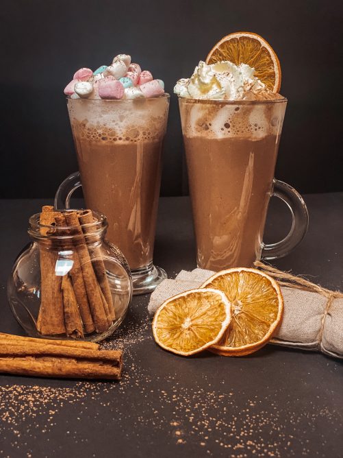 Spiced cocoa with foam and marshmallows and Spiced cocoa with whipped cream and dried orange